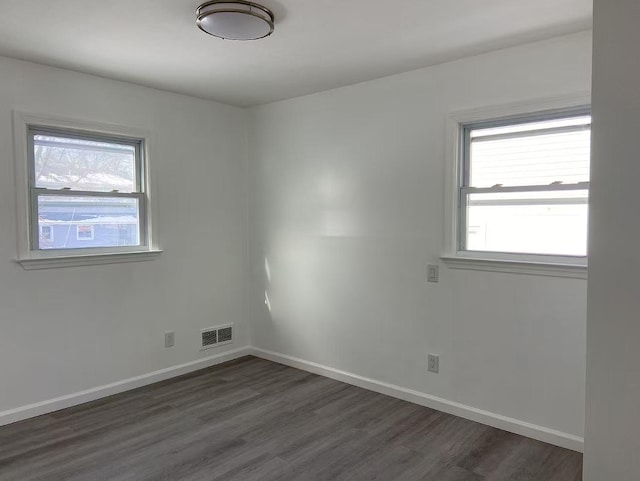 unfurnished room featuring dark hardwood / wood-style flooring