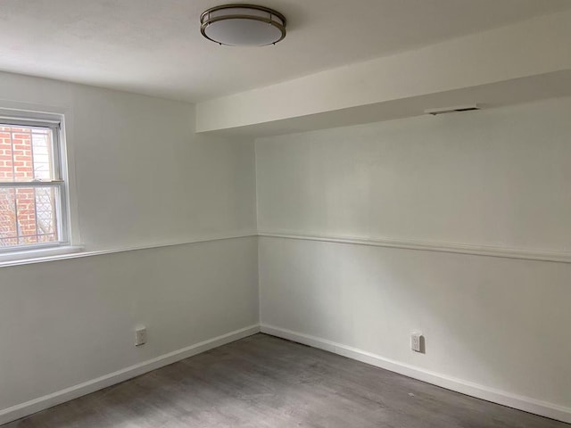 spare room featuring wood-type flooring