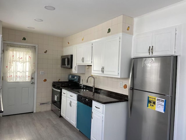 kitchen featuring sink, light wood-type flooring, white cabinets, and appliances with stainless steel finishes