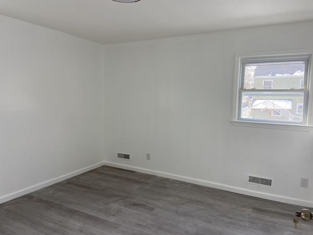 unfurnished room featuring dark hardwood / wood-style flooring