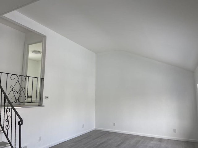 additional living space with lofted ceiling and dark hardwood / wood-style flooring