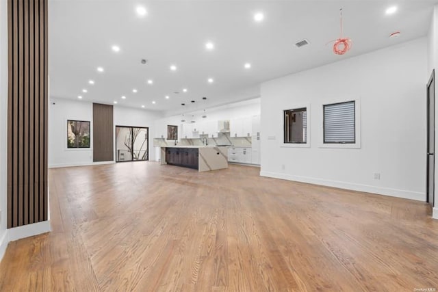 unfurnished living room with light wood-type flooring