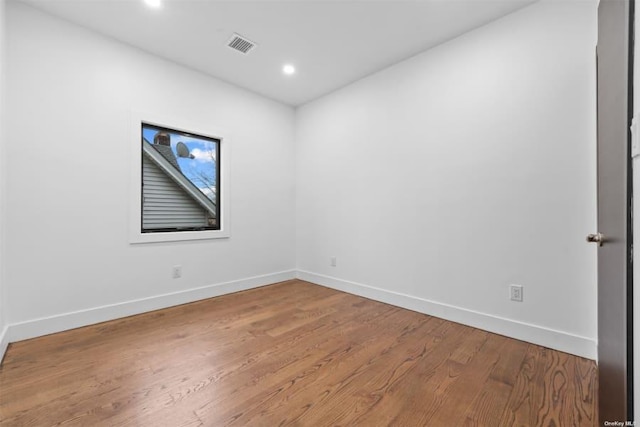 spare room with wood-type flooring