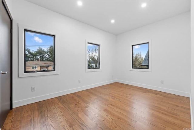 spare room featuring wood-type flooring