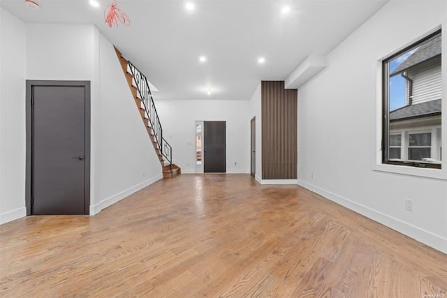 unfurnished living room with light hardwood / wood-style flooring