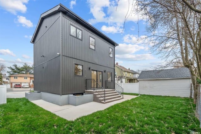 rear view of property featuring a lawn