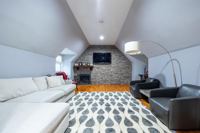 living room with wood-type flooring, a fireplace, and vaulted ceiling