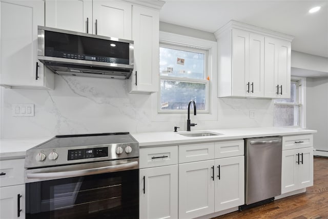 kitchen featuring a healthy amount of sunlight, sink, white cabinets, and appliances with stainless steel finishes