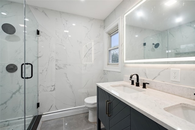 bathroom featuring a shower with door, baseboard heating, tile walls, vanity, and toilet