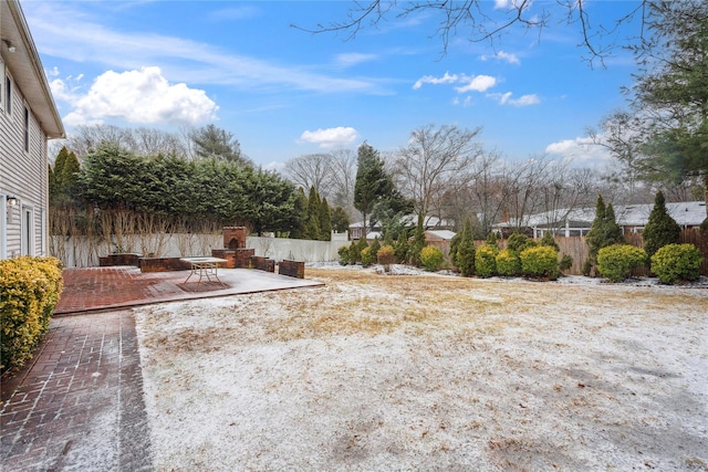 view of yard featuring a patio area and an outdoor fireplace