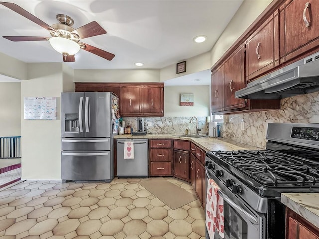 kitchen featuring tasteful backsplash, ceiling fan, stainless steel appliances, and sink