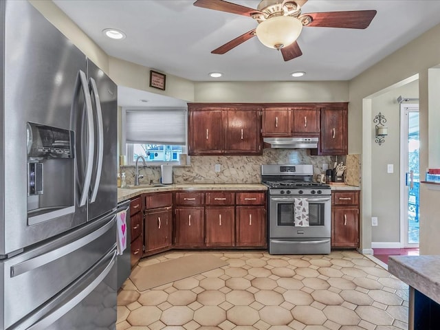 kitchen featuring ceiling fan, stainless steel appliances, sink, and backsplash