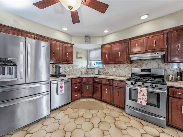 kitchen featuring tasteful backsplash, ceiling fan, appliances with stainless steel finishes, and sink