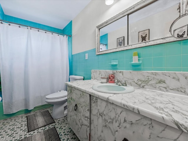 bathroom featuring tile walls, tile patterned flooring, vanity, toilet, and a shower with curtain