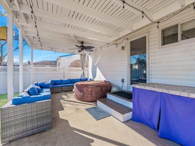 view of patio / terrace featuring a hot tub, an outdoor hangout area, and ceiling fan