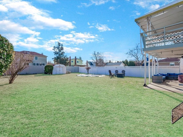 view of yard with a storage shed, an outdoor hangout area, and a patio area