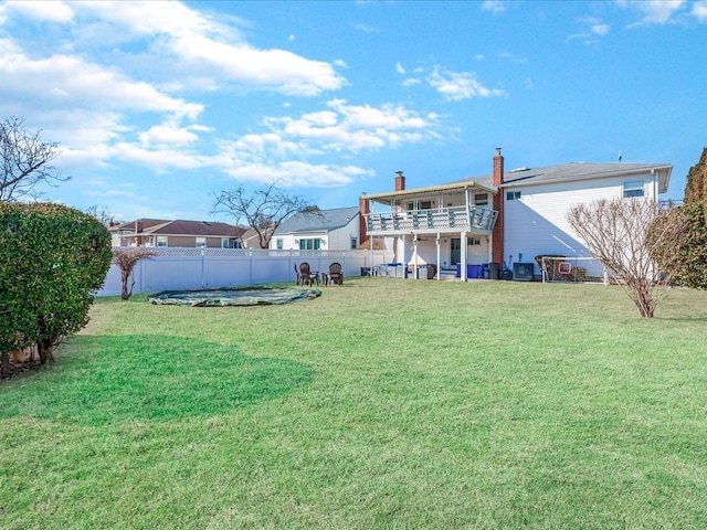 view of yard with a balcony