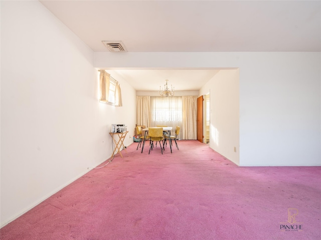 unfurnished dining area with a notable chandelier and carpet