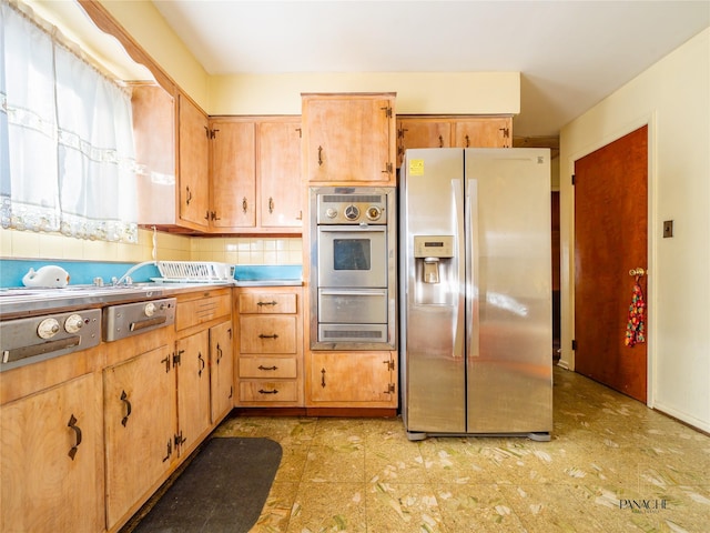 kitchen with decorative backsplash and appliances with stainless steel finishes