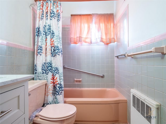 full bathroom featuring shower / tub combo with curtain, tile walls, radiator heating unit, vanity, and toilet