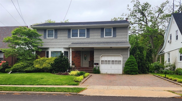 view of front facade with a garage and a front lawn