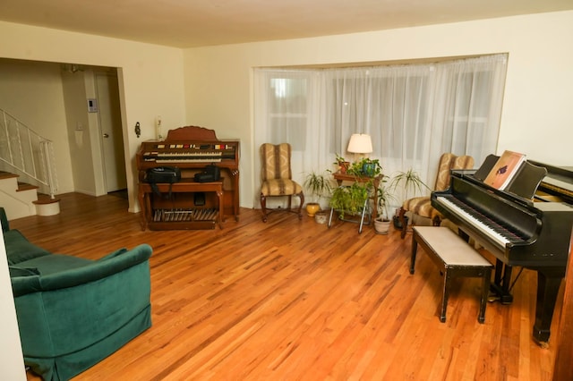 sitting room featuring stairs and wood finished floors