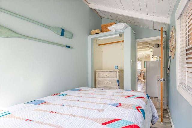 47 Woodcliff Trl, Baiting Hollow, NY 11933 - bedroom with wooden ceiling, vaulted ceiling with beams, hardwood / wood-style floors, and stainless steel fridge
