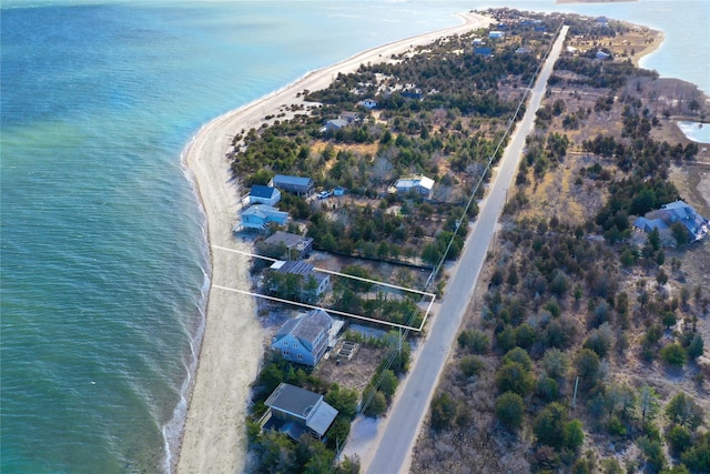 birds eye view of property featuring a water view and a beach view