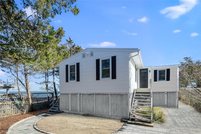 manufactured / mobile home with stairs and fence