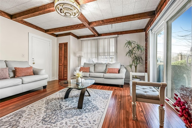 living room with coffered ceiling, dark wood-type flooring, and beamed ceiling