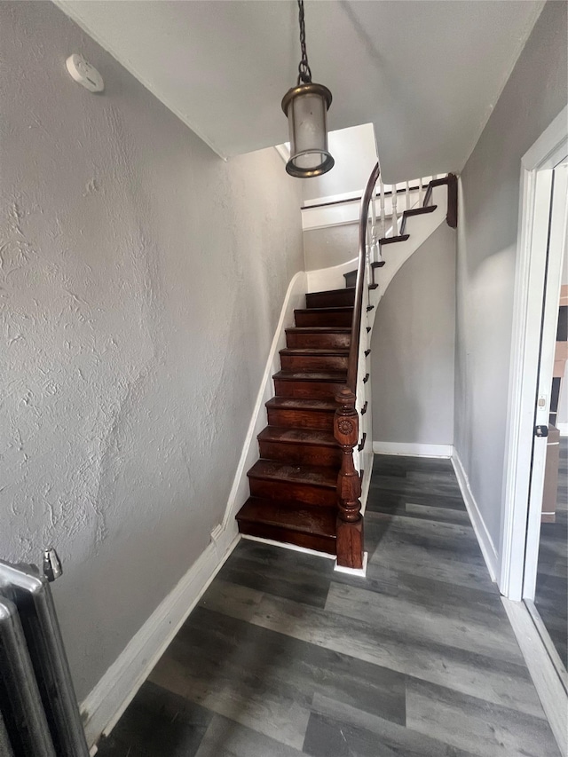 stairs with baseboards and wood finished floors