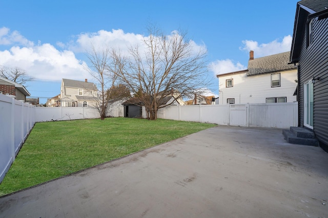 view of yard with a shed and a patio area