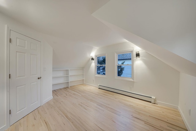 bonus room featuring lofted ceiling, light wood-type flooring, built in features, and baseboard heating