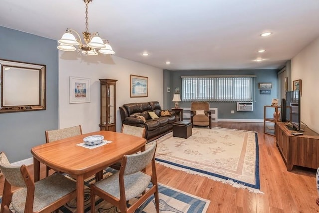 dining space featuring an inviting chandelier, recessed lighting, light wood-style flooring, and baseboards