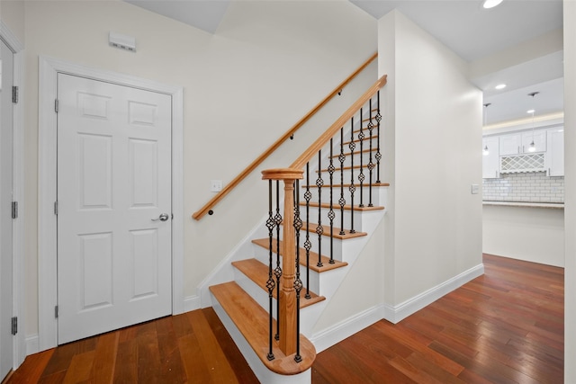 staircase featuring wood-type flooring