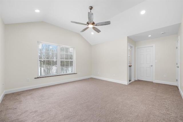 carpeted empty room featuring ceiling fan and lofted ceiling