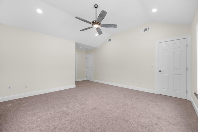 empty room with ceiling fan, carpet floors, and vaulted ceiling