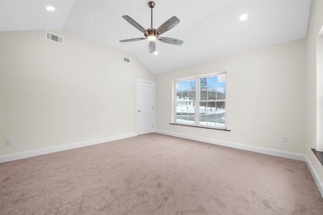 spare room with vaulted ceiling, carpet, and ceiling fan