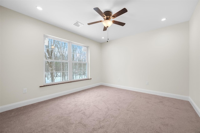 carpeted spare room with ceiling fan