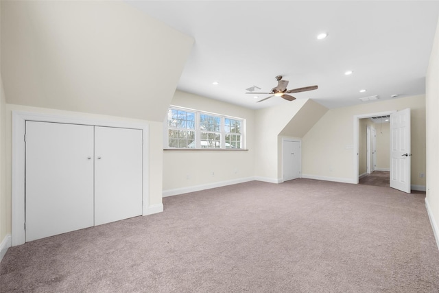 bonus room featuring ceiling fan and carpet flooring