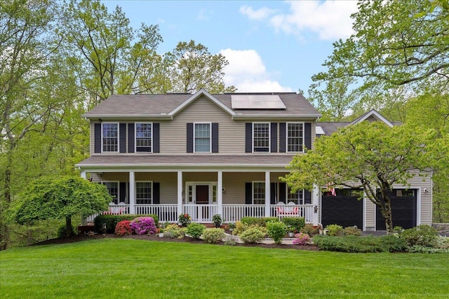 6 W Causeway, Cortlandt Manor, NY 10567 - colonial-style house featuring roof mounted solar panels, covered porch, and a front lawn