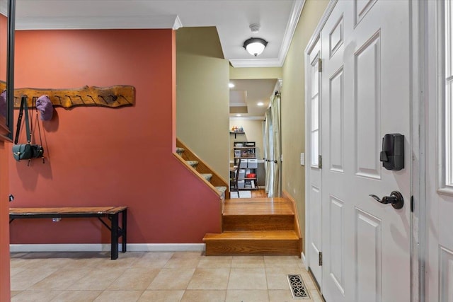 6 W Causeway, Cortlandt Manor, NY 10567 - tiled entrance foyer featuring baseboards, visible vents, ornamental molding, and stairway