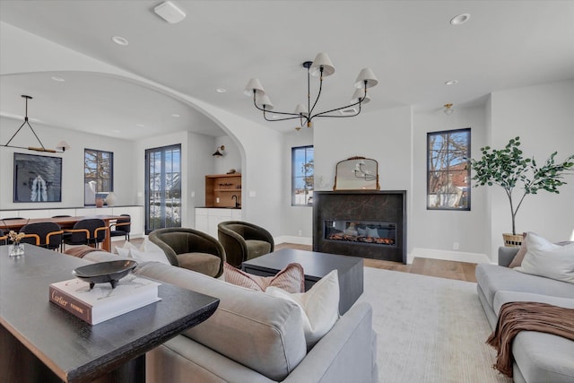 living room featuring an inviting chandelier and light wood-type flooring