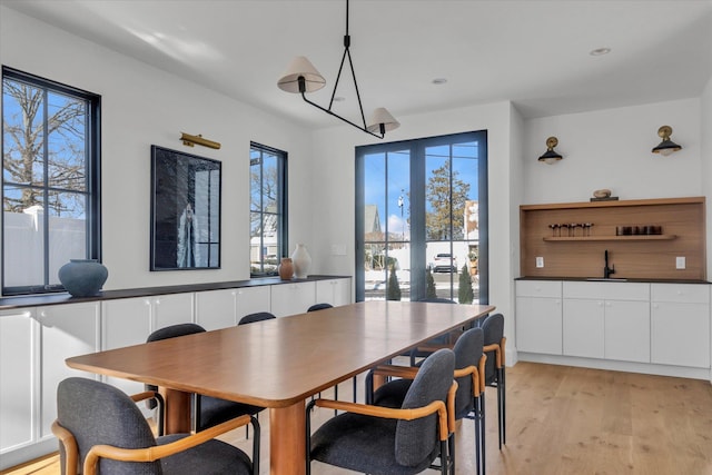 dining room with sink and light wood-type flooring