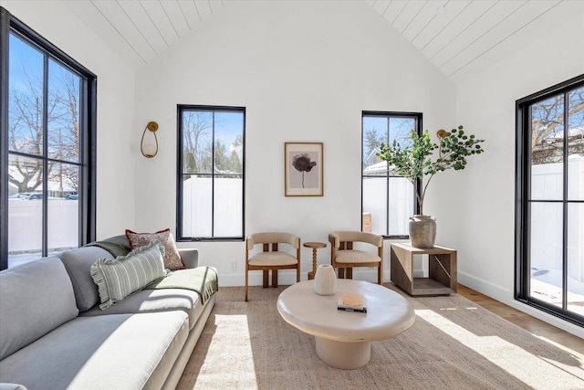 living room featuring hardwood / wood-style floors, wood ceiling, plenty of natural light, and high vaulted ceiling