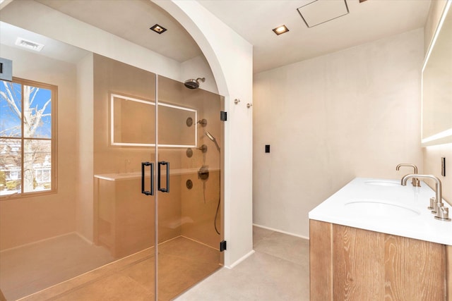 bathroom featuring an enclosed shower and vanity