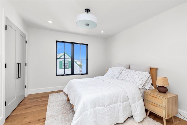 bedroom with hardwood / wood-style flooring