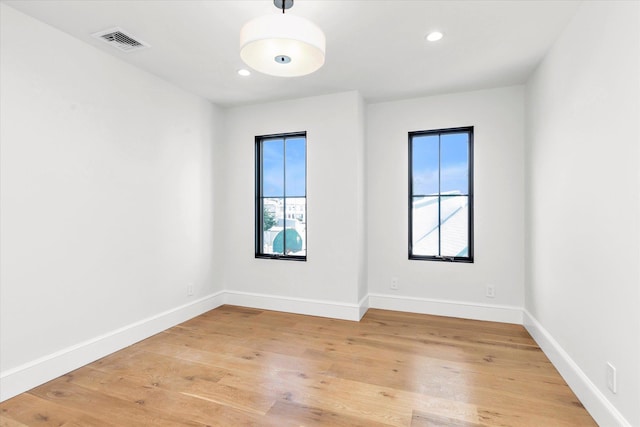 spare room with hardwood / wood-style flooring