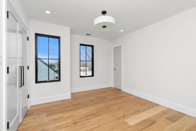 spare room with light wood-type flooring