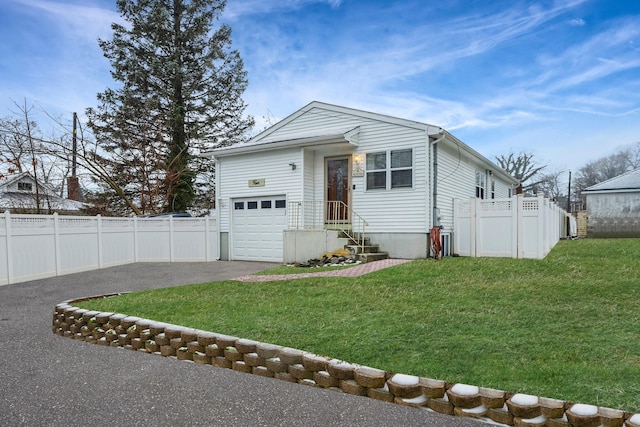 view of front of property featuring a garage and a front lawn